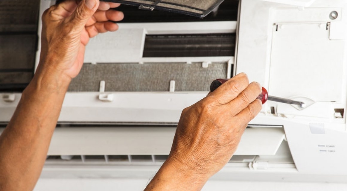 Technician fixing heat pump